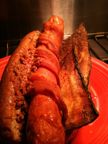 fried bacon wrapped hot dog with zucchini and mystery tapenade